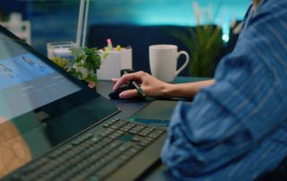 Close up of photographer hands using graphic tablet and stylus