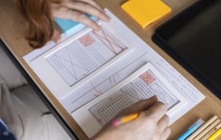 female-web-designer-taking-notes-office